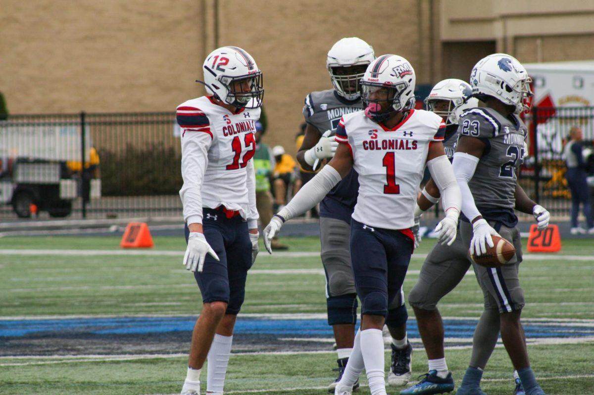 #12 Miles Hayes and #1 Tavin Harville celebrate a defensive stop at Monmouth. Photo credit: Jonathan Hanna