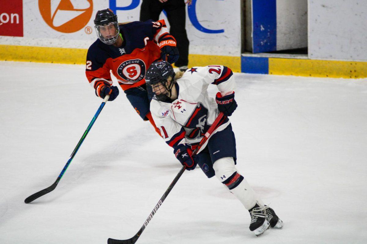 Kyleigh Hanzlik carries the puck against Syracuse. Photo credit: Nathan Breisinger