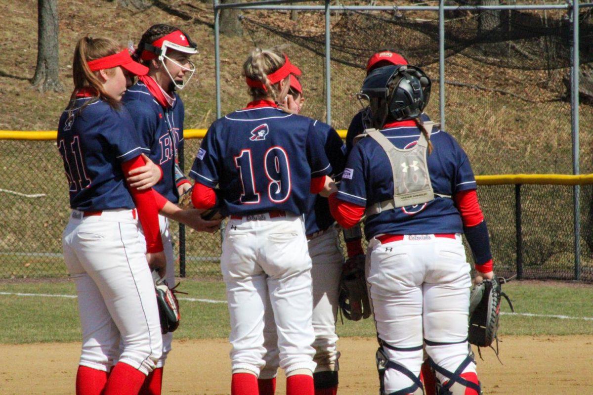 RMU softball huddles before their game against Detroit Mercy. Photo credit: Tyler Gallo