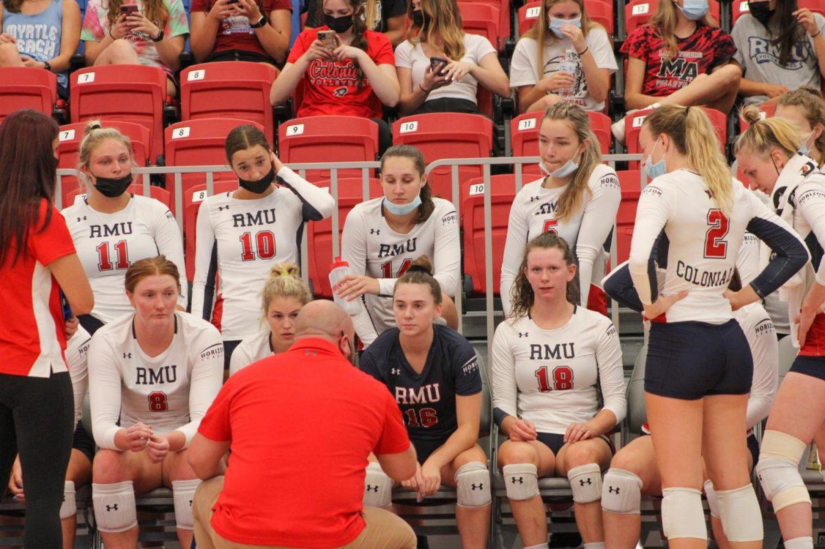 Volleyball meets with assistant (now head) coach Danny Doherty during a timeout against Duquesne. Photo credit: Tyler Gallo