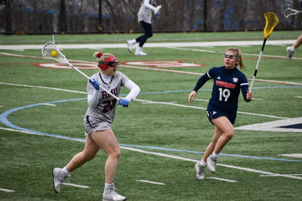 Abbie Elliott looks to pass around Cat Kopchia in the second quarter. Photo Credit: Megan Frey