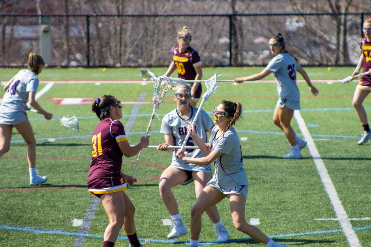 Maggie Diebold and two RMU players fight for a ball in Wednesdays game. Photo credit: Bailey Noel