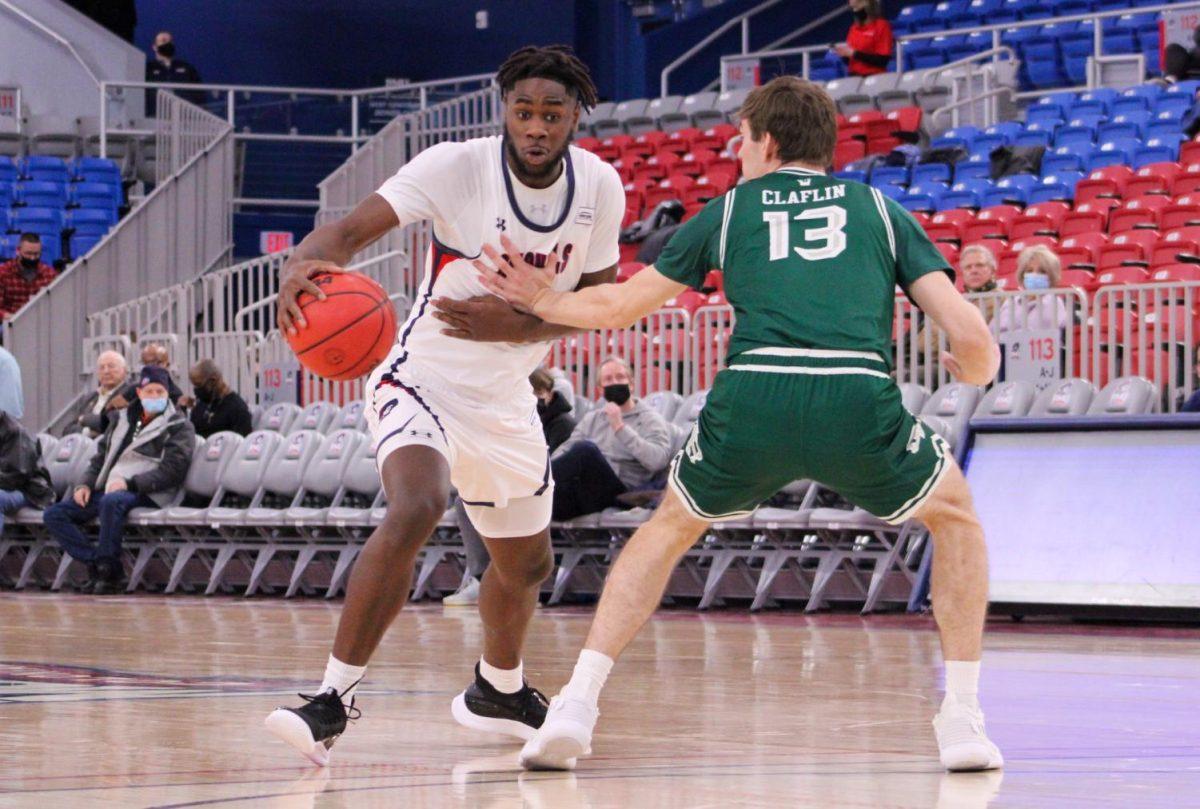 Justin Winston weaves around Sam Claflin of Green Bay. Photo credit: Tyler Gallo