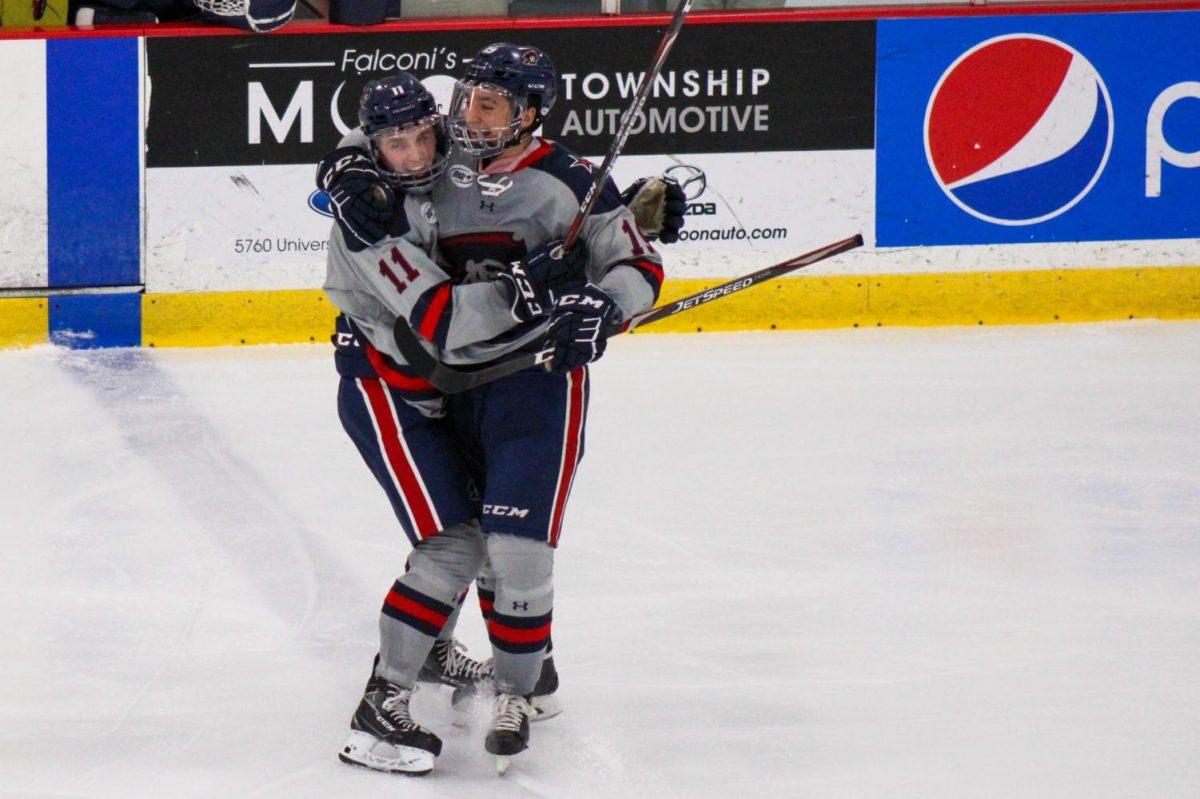 Brian Kramer and Randy Hernández celebrate a goal against Mercyhurst. Photo credit: Nathan Breisinger