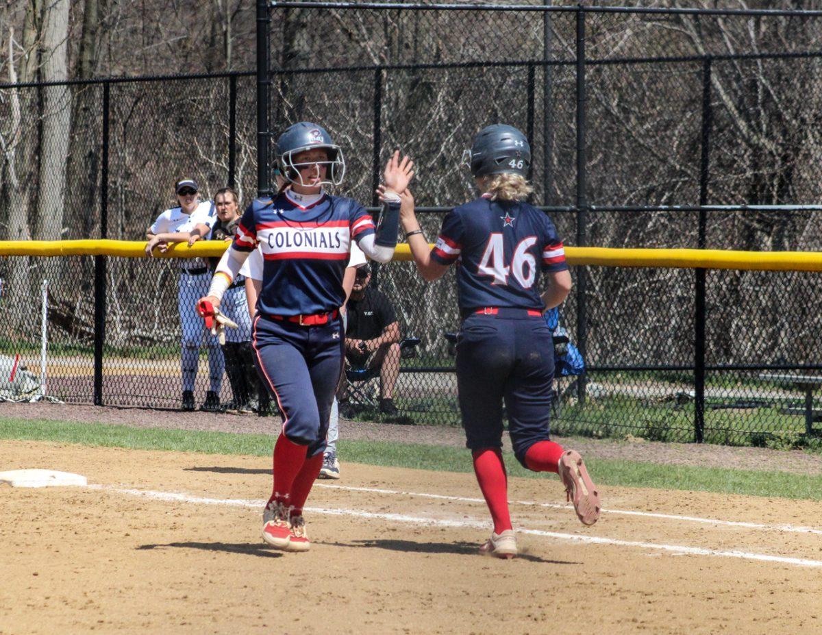 Meadow Sacadura high fives Bailee Bertani in game one of the doubleheader. Photo credit: Cameron Macariola