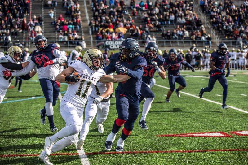 Bryants Tom Kennedy looks to weave around Robert Morris Gerald Ferguson at Joe Walton Stadium. Photo credit: David Auth