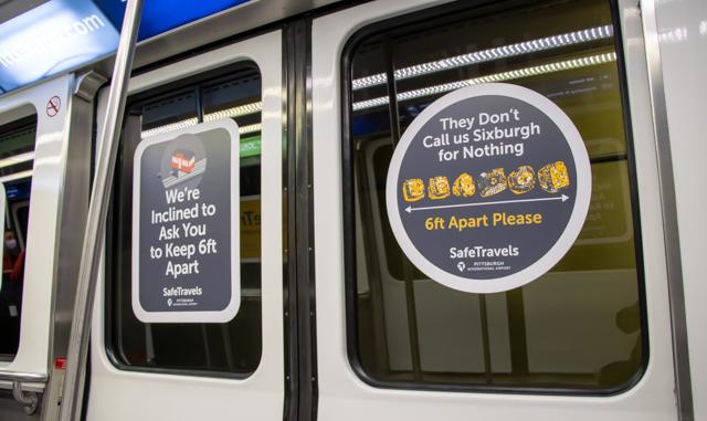 Mask Mandate signs line the doors of airport transportation at Pittsburgh International Airport