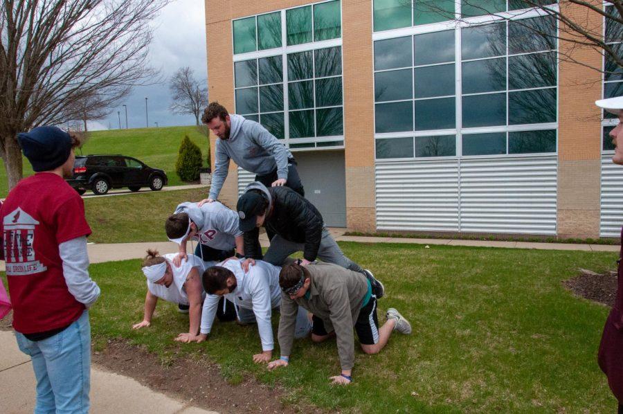 Members of Alpha Chi Rho practice their pyramid routine during the Greek Week obstacle course on April 3. 