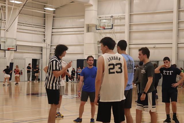 A referee talks to several brothers before the game.