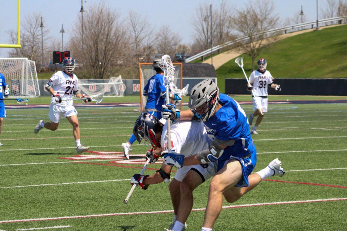 An Air Force player attacks Jonny Chaisson during RMUs victory over the Falcons. Photo credit: Cameron Macariola