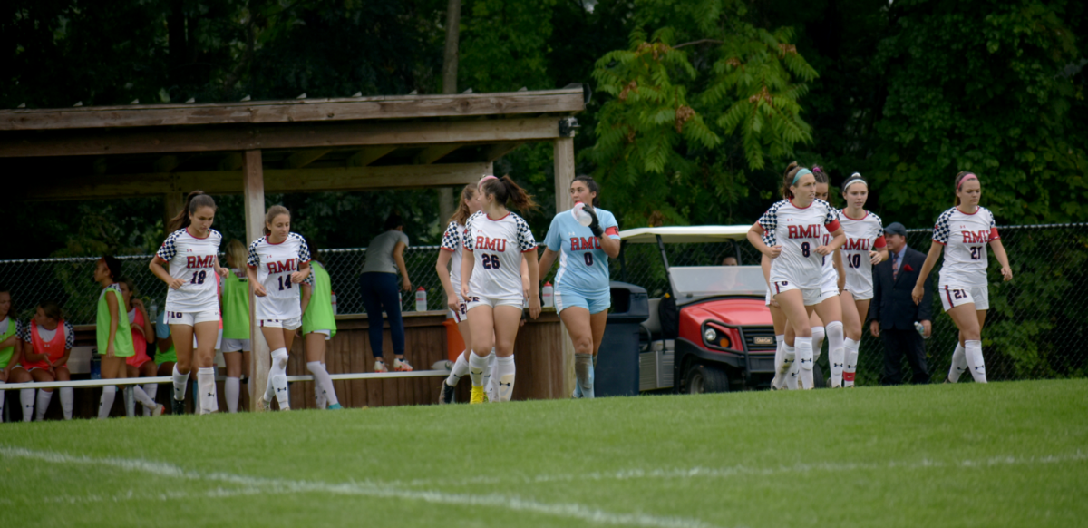 The Colonials run onto the field against Delaware State on September 11, 2022 Photo credit: Ellie Whittington