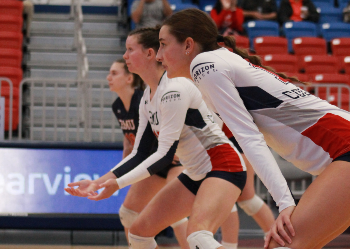 Annie Monaco, Abby Ryan and Allena Carmody are set before a serve