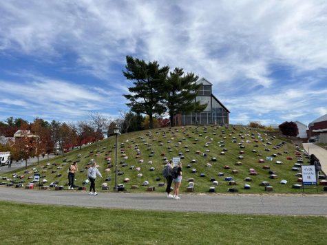 An assortment of backpacks placed on the hill leading to RMU's Rogal Chapel.