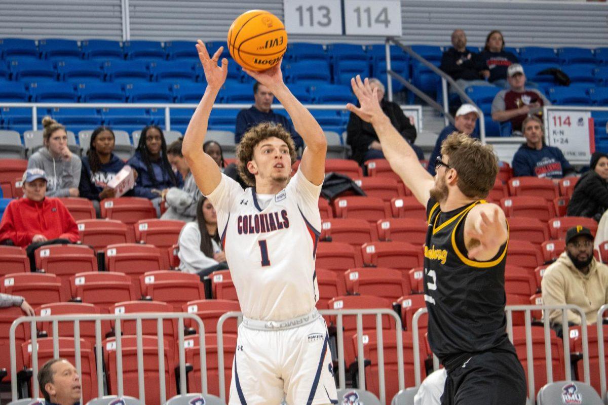 Robert Morris guard TJ Wainwright takes a three-point shot over Pitt Greensburg guard Matthew Marinchak in the Colonials 84-49 win over the Bobcats on Nov. 9, 2022.