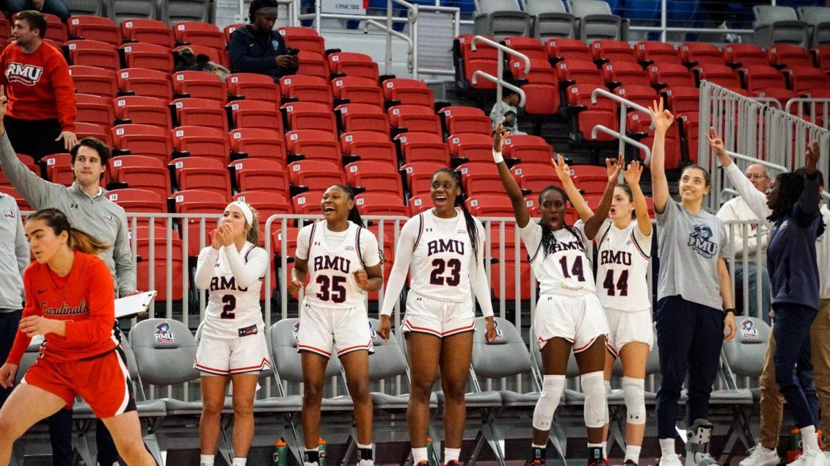 The bench celebrates a three-point basket in the 87-48 Photo credit: Sydney Riker