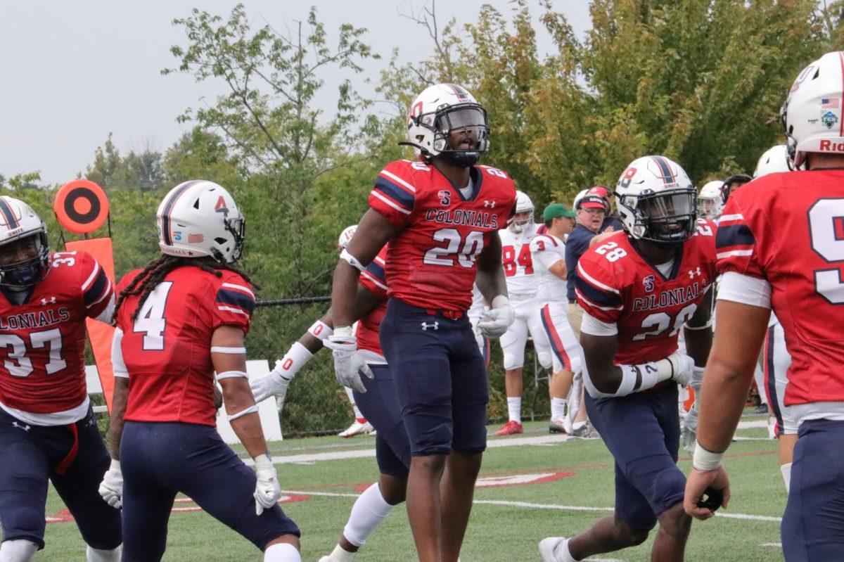 Dakarai Cabell (20) and the rest of the defense celebrate a big play in the game against Dayton Photo credit: Ethan Morrison