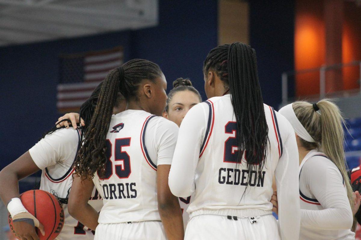 The team huddles during the 49-36 win over St. Francis Photo credit: Malena Kaniuff