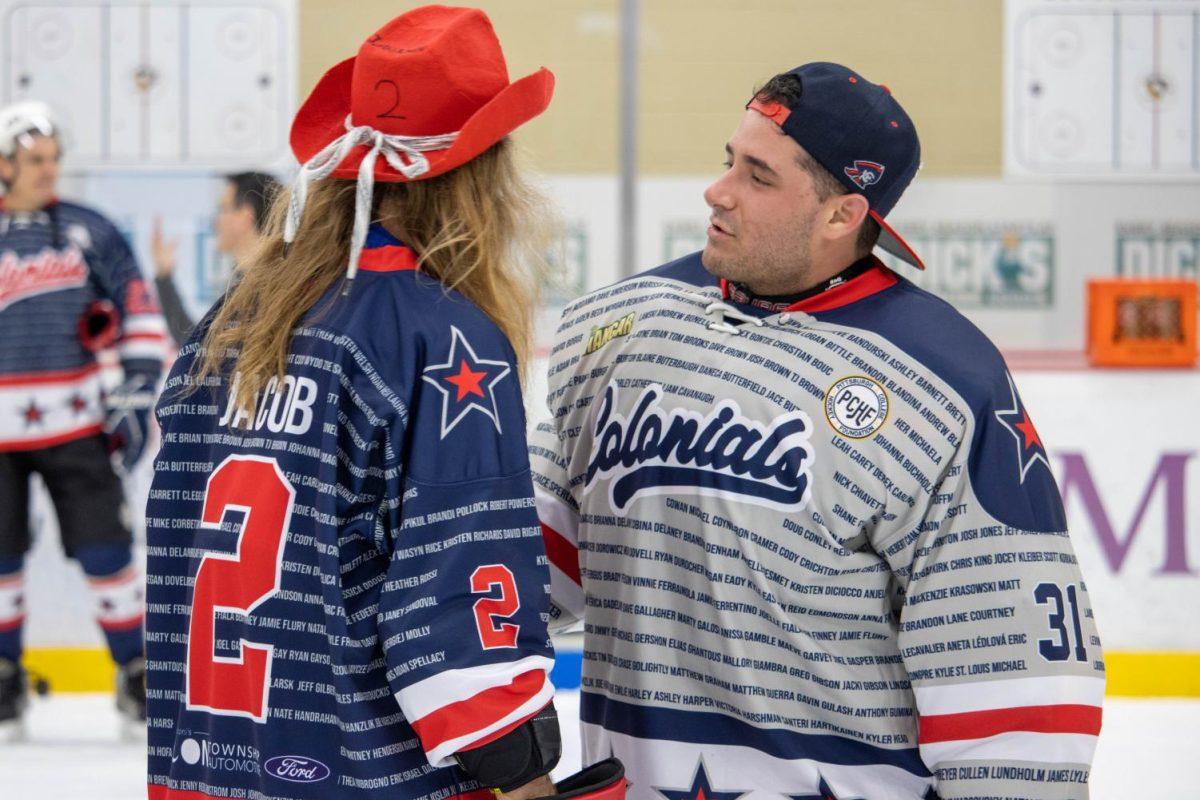 Jacob from On The Bench and Travis Marzina share a moment after Celebrity Hockey Face-Off