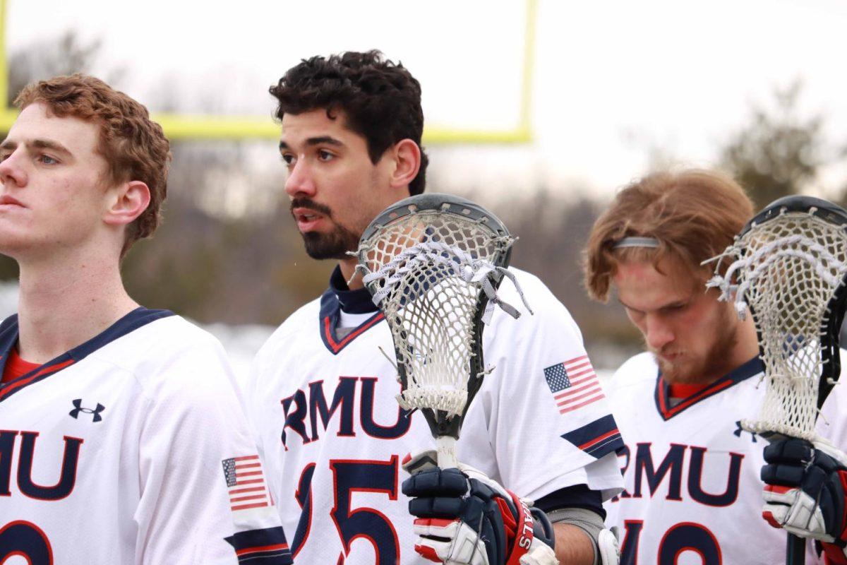 Down (middle) stands for the National Anthem before the game against Bucknell on February 12, 2021 Photo credit: Ethan Morrison