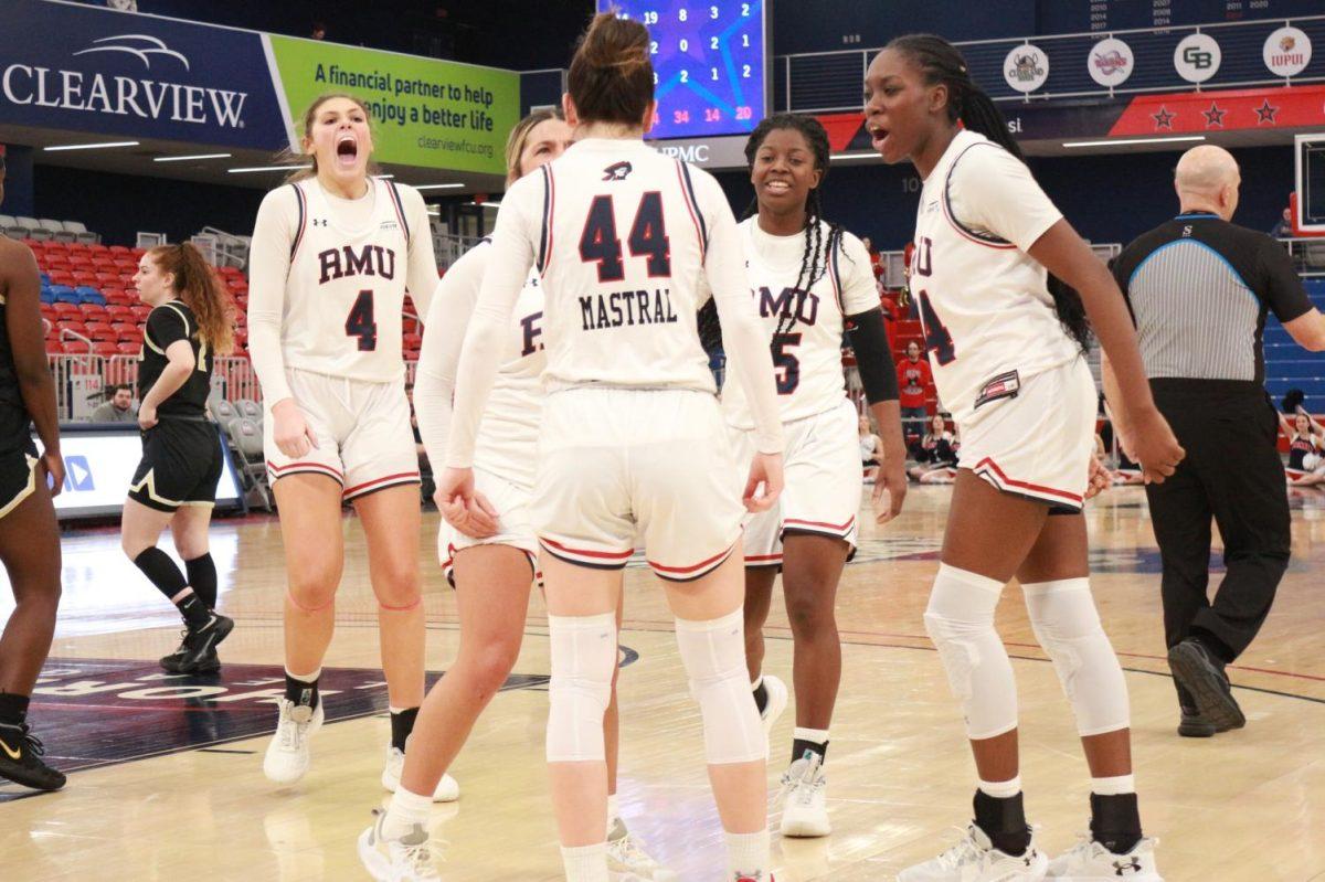 The team celebrates a basket in the 74-43 win over Oakland