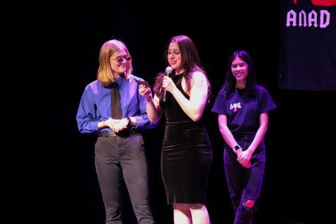 Liz Sarasnick and Paige Matey of RMU Club Volleyball read off facts about anorexia.