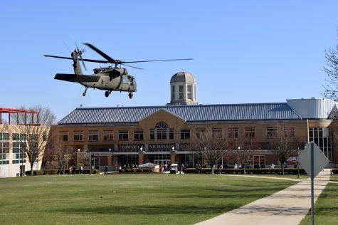 Blackhawk helicopter flies over RMUs Nicholson Center