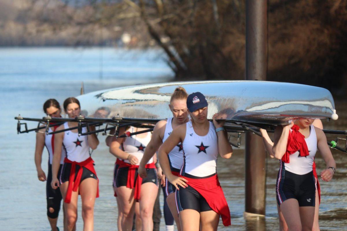 The team carries their boat at the Midge McPhail Boathouse on Neville Island Photo credit: Samuel Goldberg