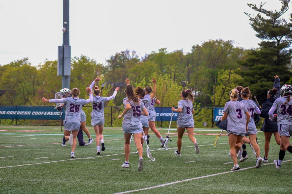 The team celebrates the MAC Semifinal win with goaltender Jamie Keller. The win punches their ticket to the MAC Championship Game on Saturday against Central Michigan.