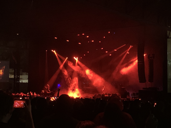 A nameless Ghoul preforms a guitar solo while Papa Emeritus IV changes outfits