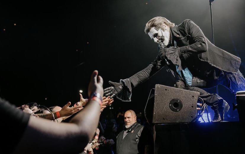 Papa Emeritus IV reaches for fans hands during a song