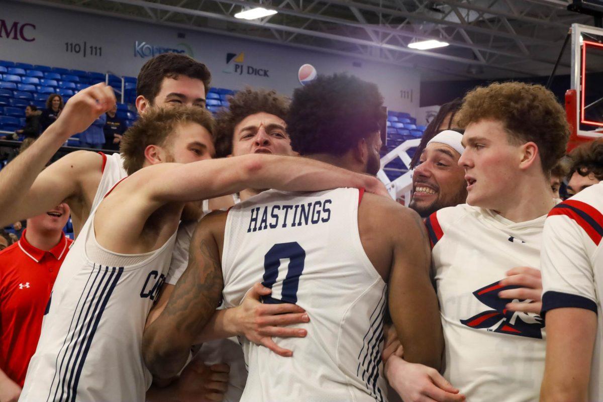 The team celebrates with Markeese Hastings (0) after hitting a three-pointer at the buzzer Photo credit: Taylor Roberts